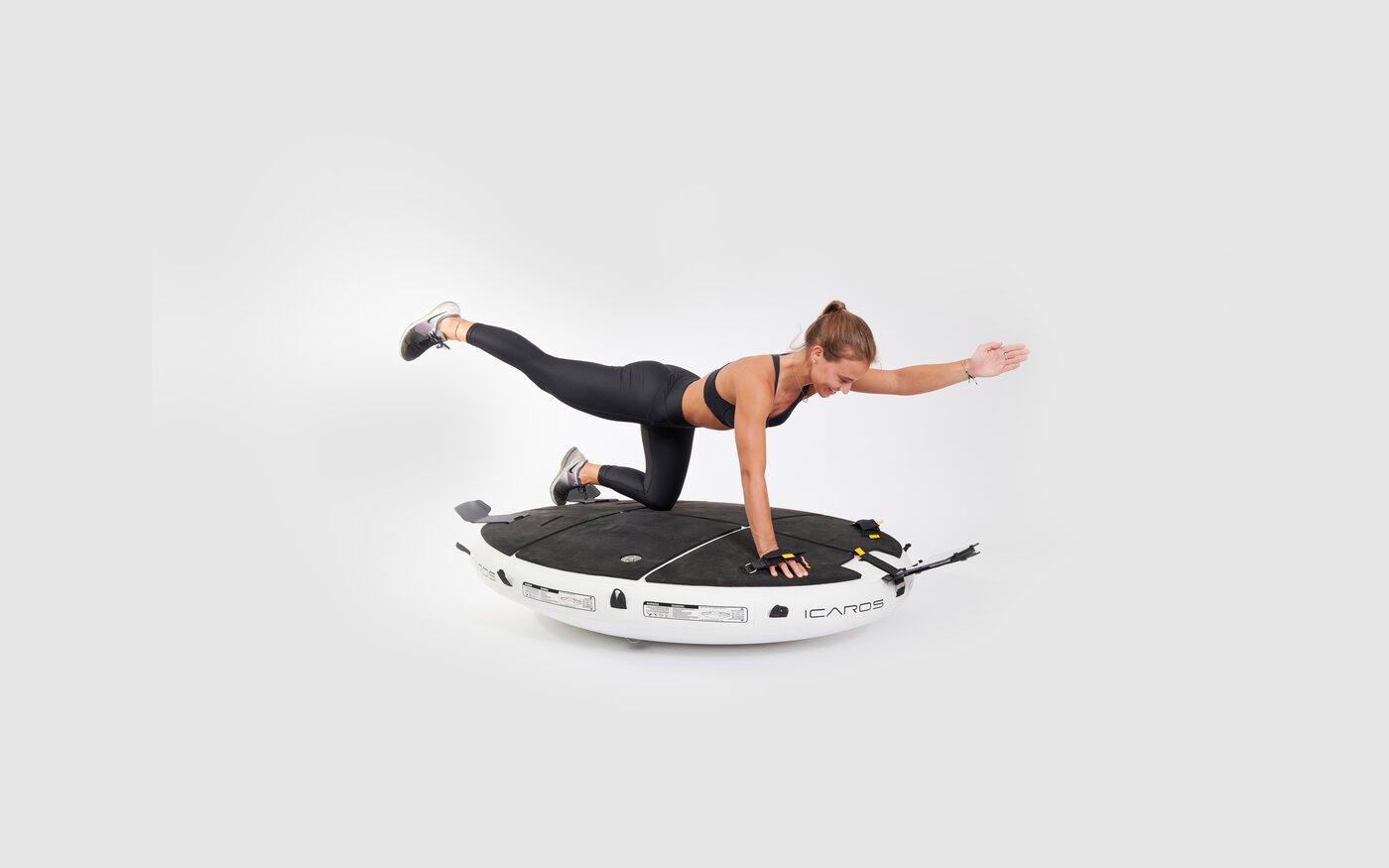 Woman training in a forearm plank on the ICAROS Cloud